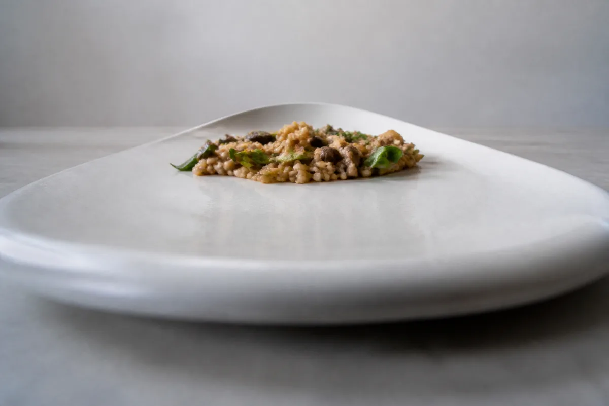 A low camera angle makes the near edge of a plate dominate while the far edge becomes a narrow arc